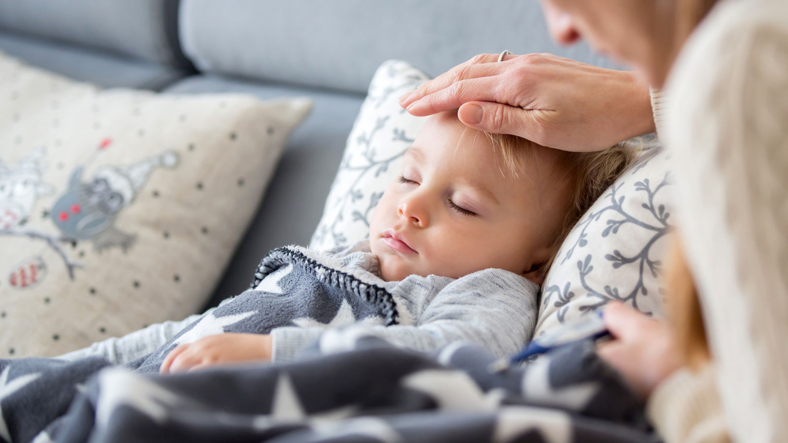 Sick child, toddler boy lying in bed with a fever, resting at home,Sick child, toddler boy lying in bed with a fever, resting at ho