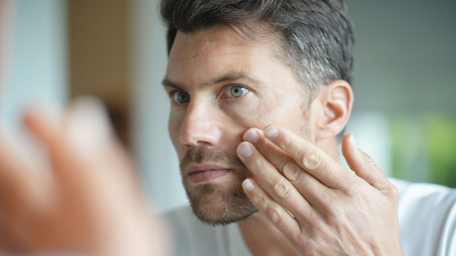 Portrait of a man in front of mirror