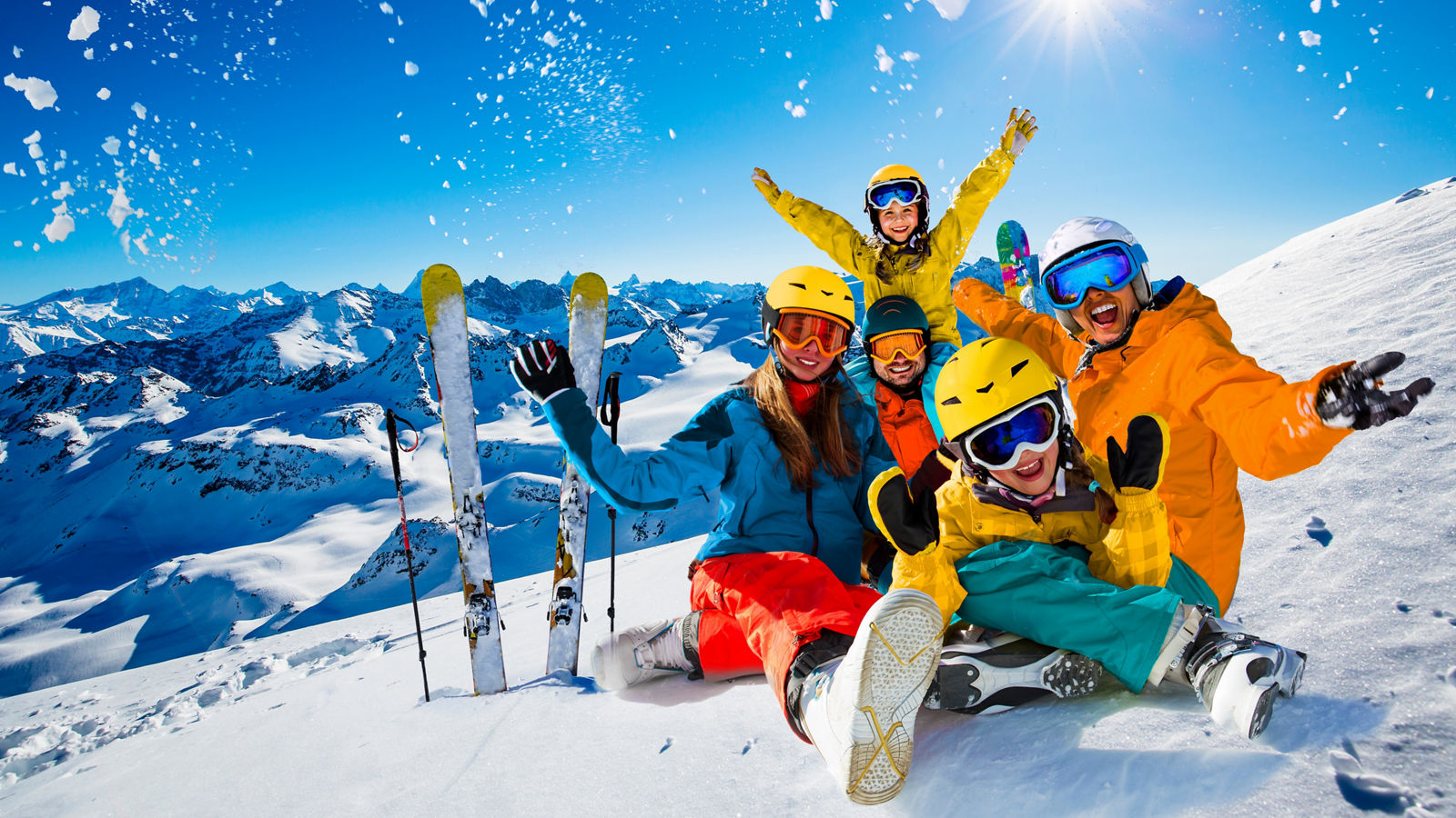 Happy family enjoying winter vacations in mountains. Playing with snow, Sun in high mountains. Winter holidays.
