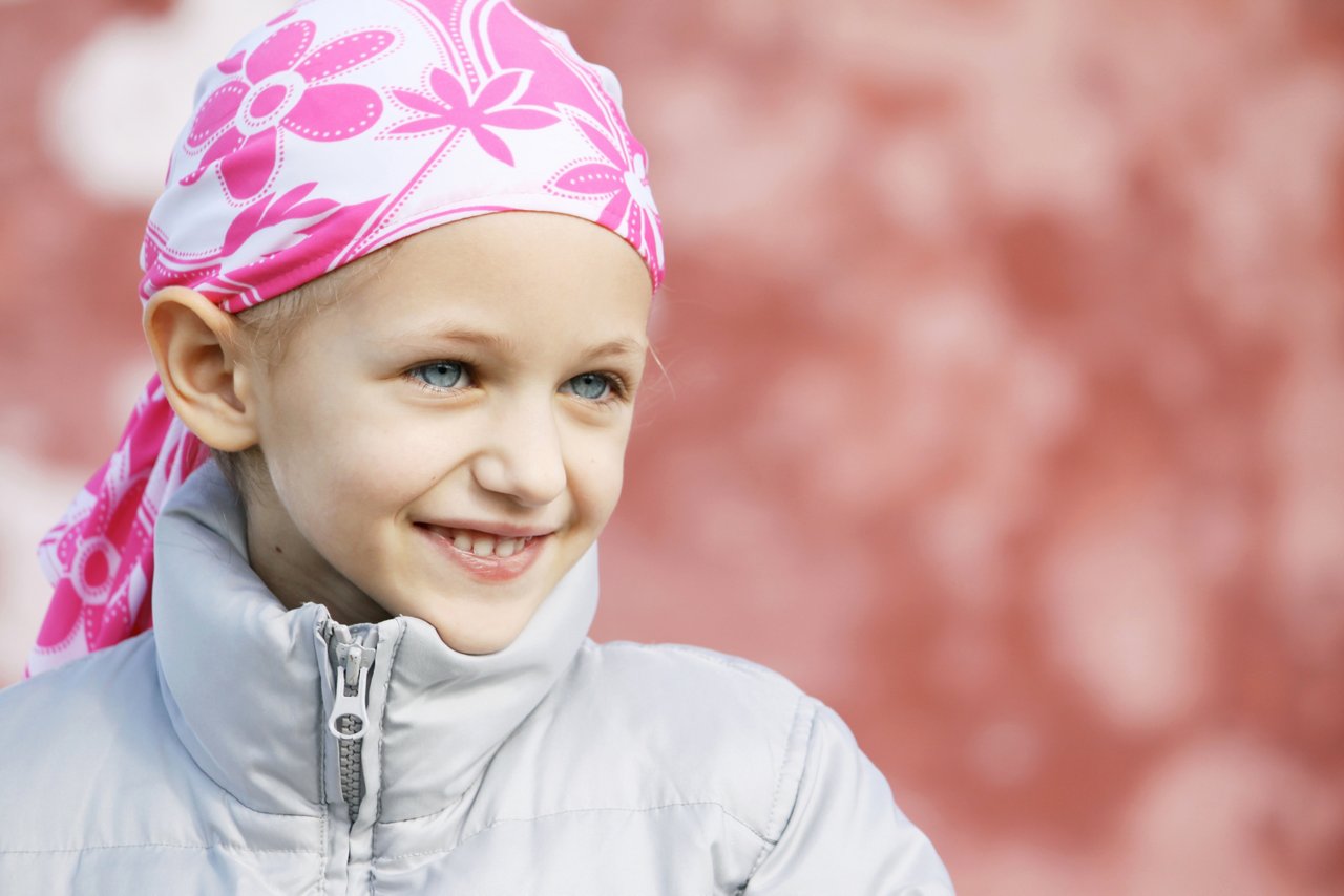 beautiful caucasian girl wearing a head scarf due to hair loss from chemotherapy fighting cancer 