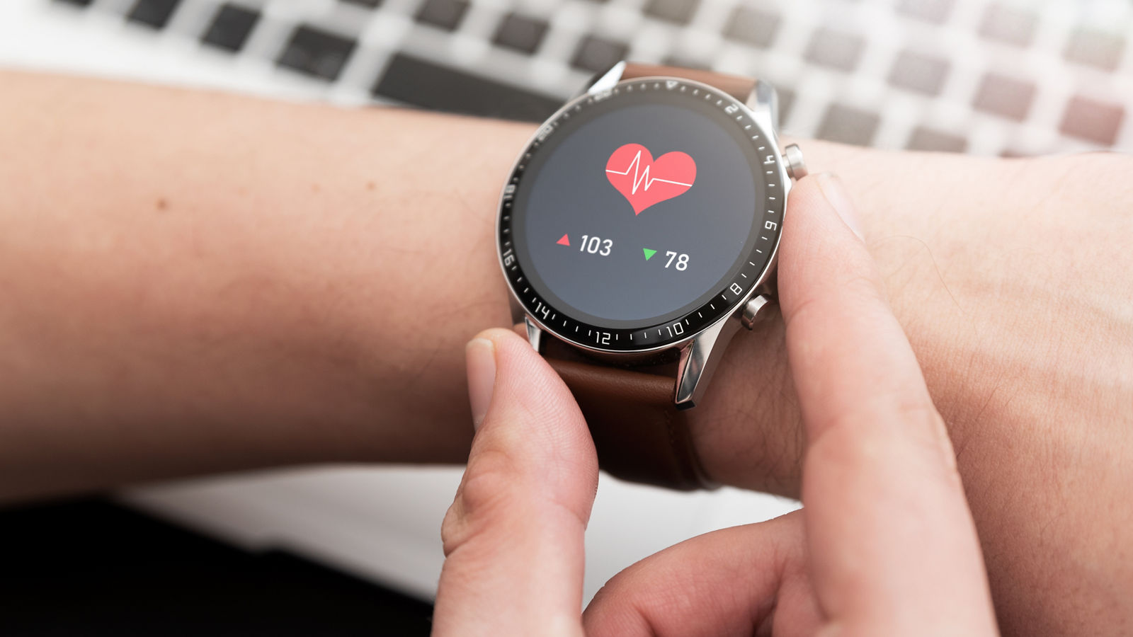 Hands with heart icon on smartwatch