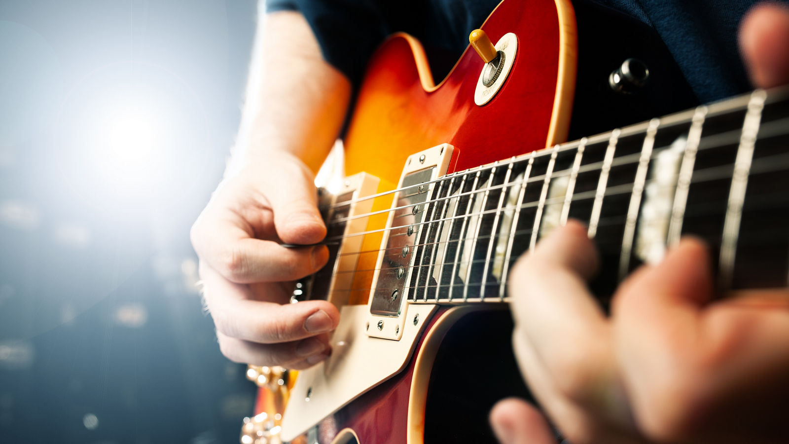 man playing on guitar close up view