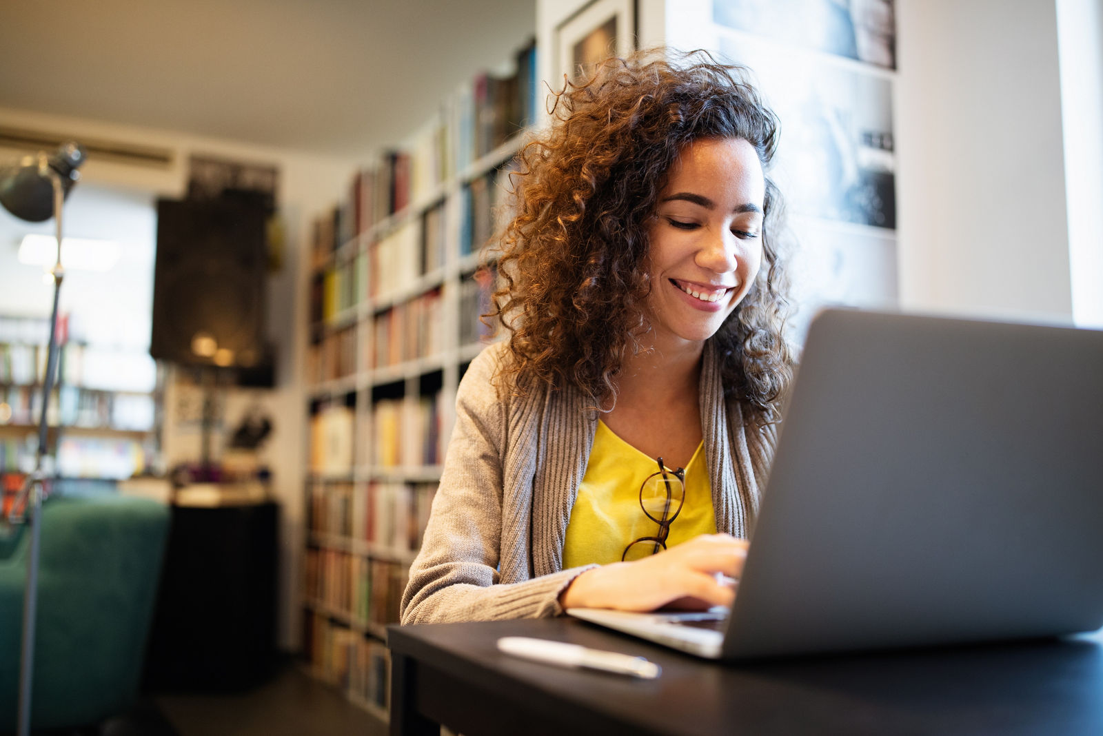 Beautiful brunette woman using notebook. Study, learning, university concept