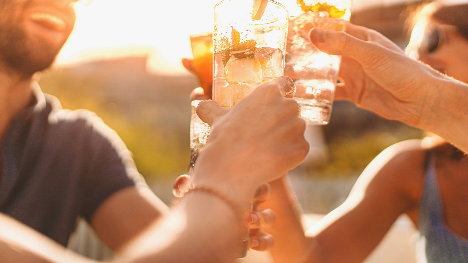 Best friends drinking mojito at counter cocktail bar restaurant - Friendship concept with young people having drunk fun toasting drinks on happy hour at outdoors pub