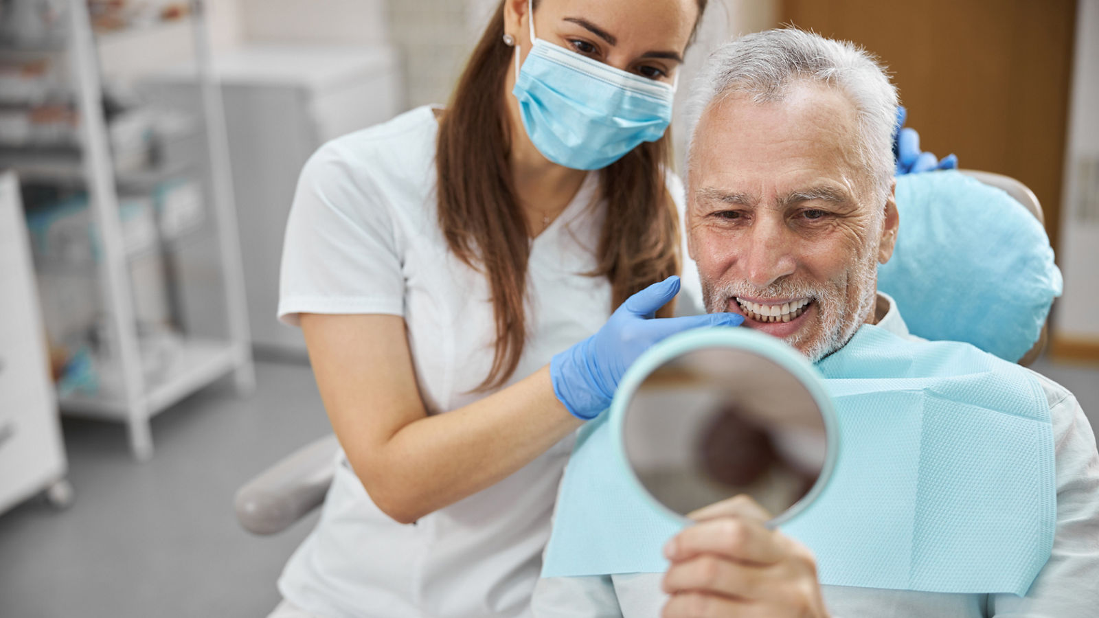Aging gentleman being happy with his new dental implant