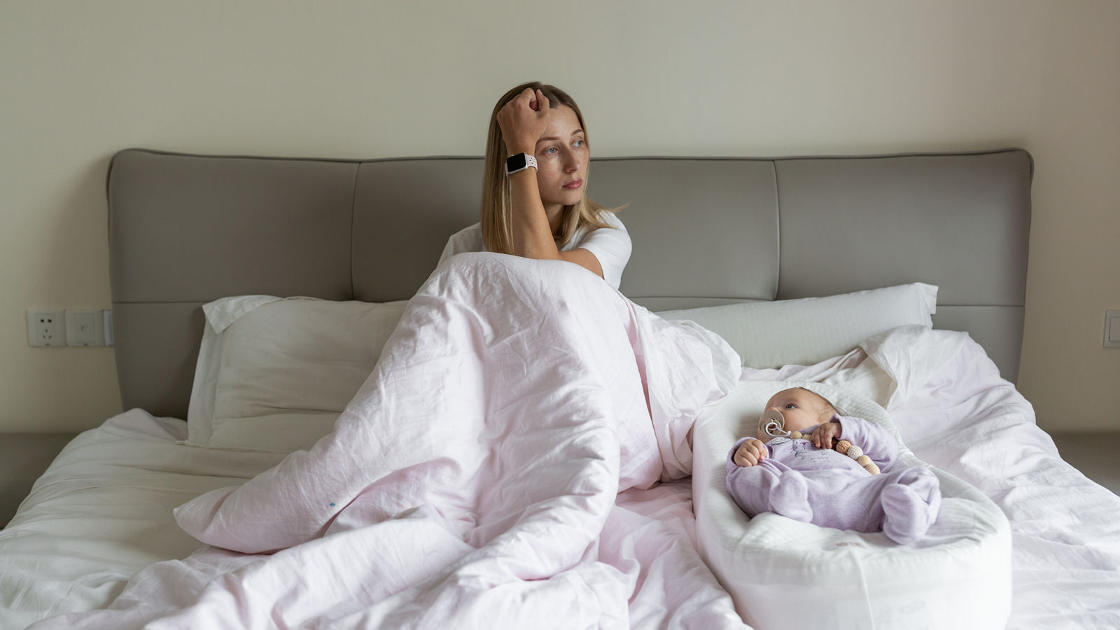 Tired Mother Suffering from experiencing postnatal depression. Health care mom motherhood stressful. Stay at home during coronavirus covid-19 pandemic quarantine