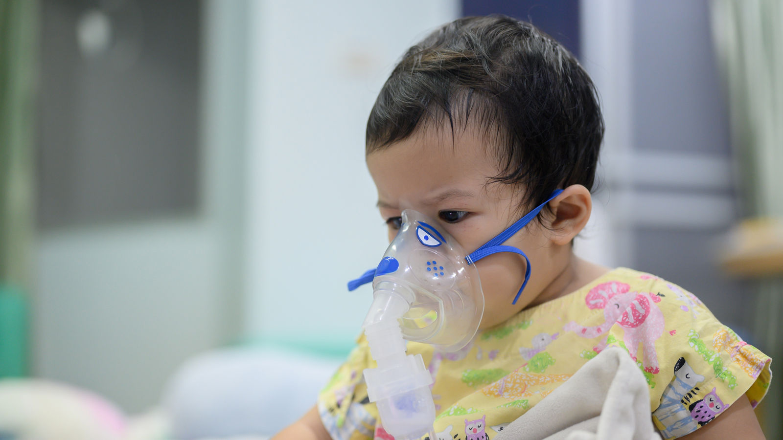 Asian baby was sick as Respiratory Syncytial Virus (RSV) in kid hospital. Thai little girl having inhaler containing medicine for stop coughing and disease flu.