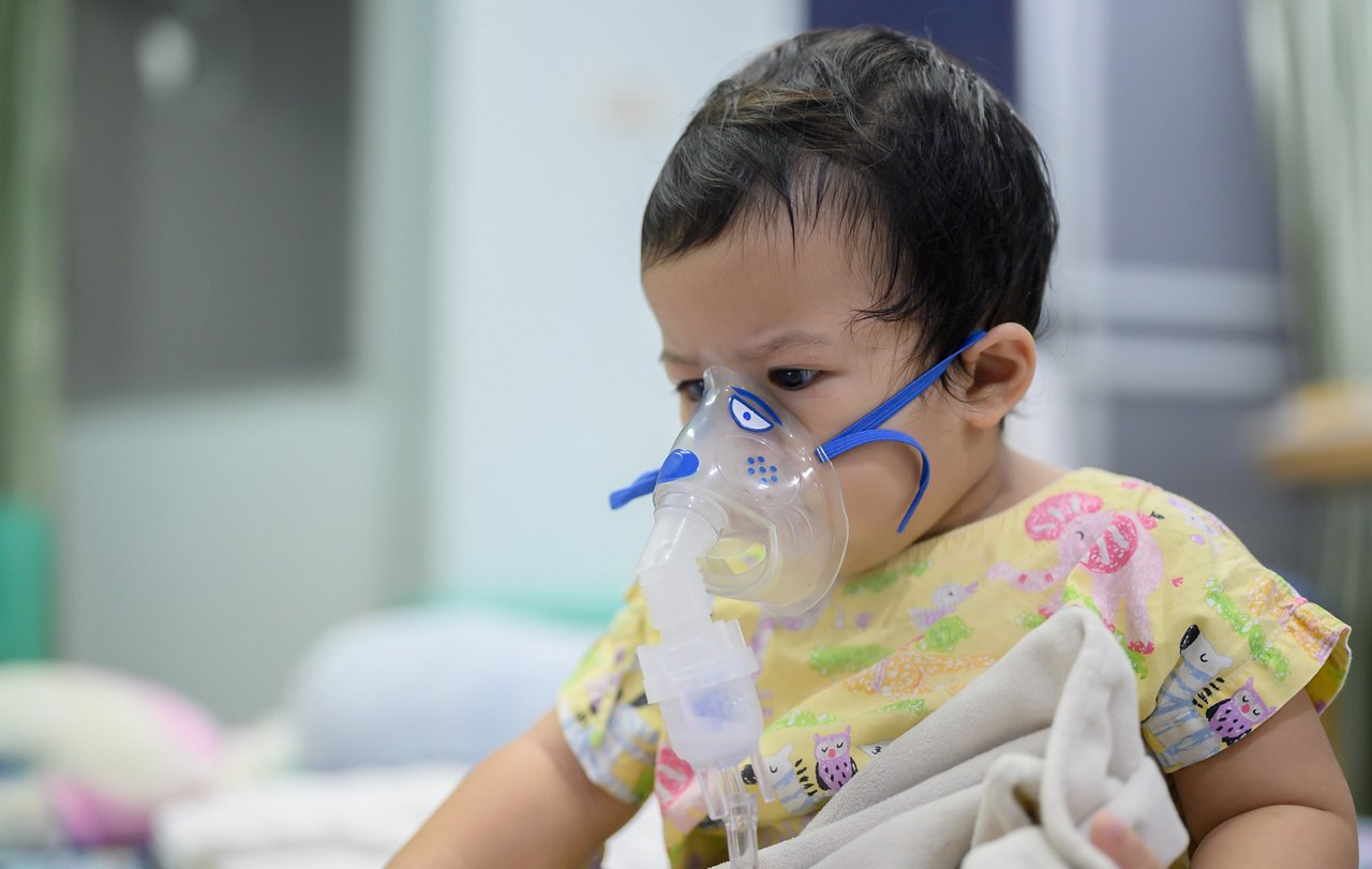 Asian baby was sick as Respiratory Syncytial Virus (RSV) in kid hospital. Thai little girl having inhaler containing medicine for stop coughing and disease flu.