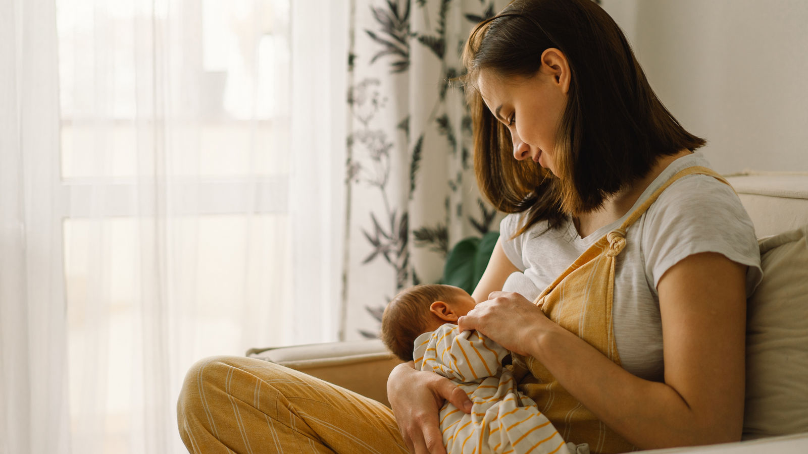 Newborn baby boy sucking milk from mothers breast. Portrait of mom and breastfeeding baby.,Newborn baby boy sucking milk from mothers breast. Portrait of m