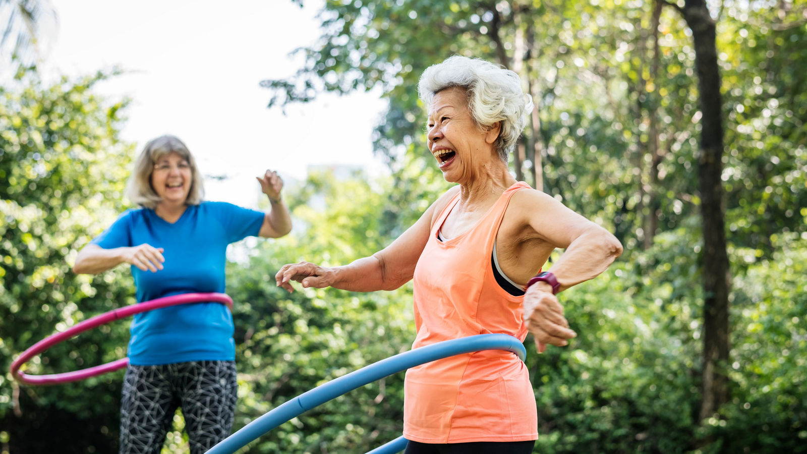 Senior woman exercising with a hula hoop