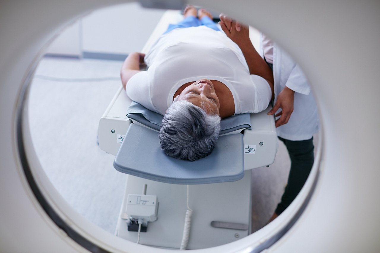 Shot of a senior woman being comforted by a doctor before and MRI scan.