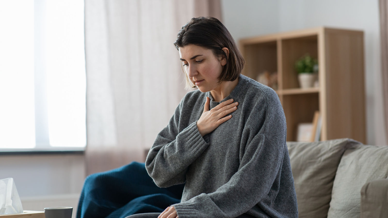 sad woman having panic attack at home