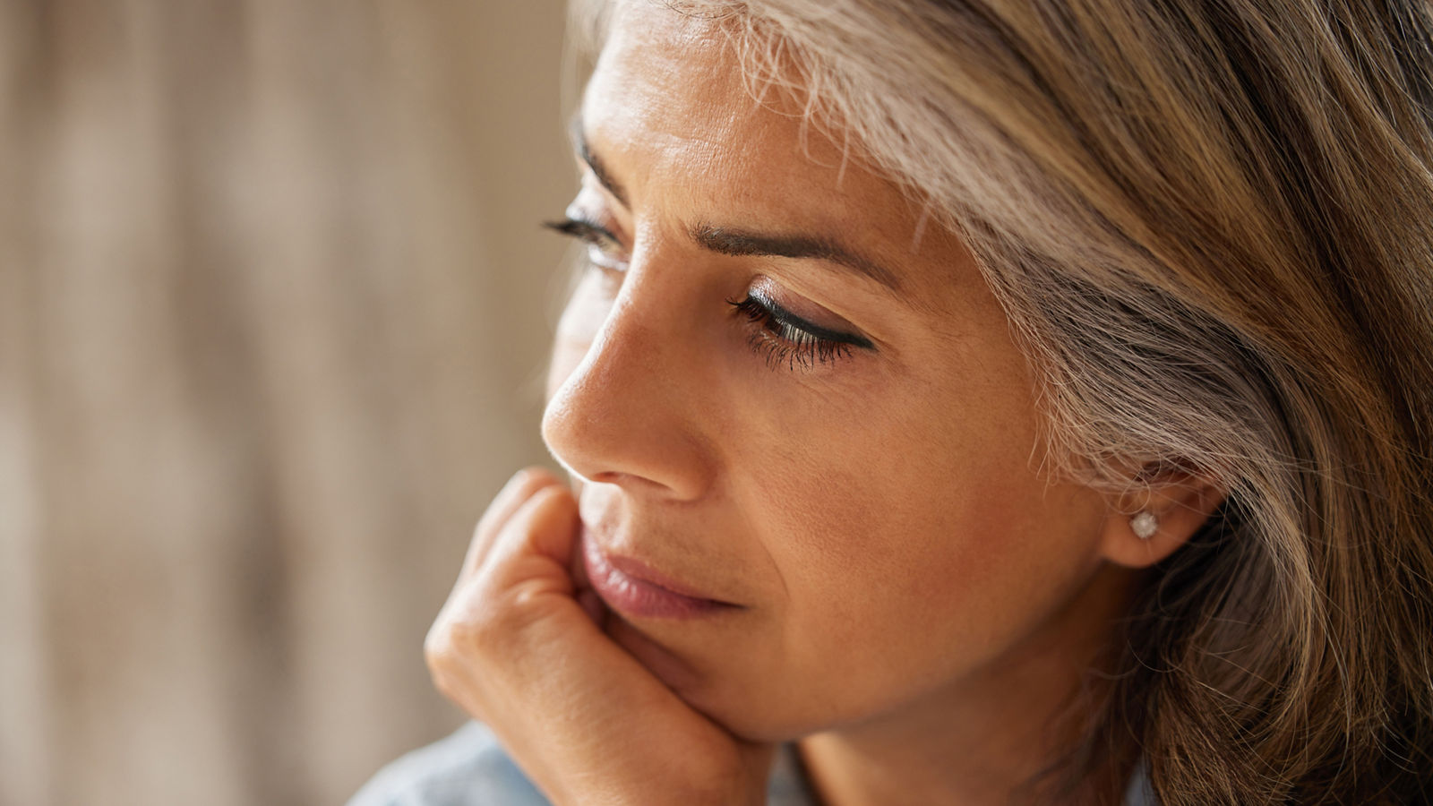 Close Up Shot Of Thoughtful Mature Woman Looking Out Of Window At Home