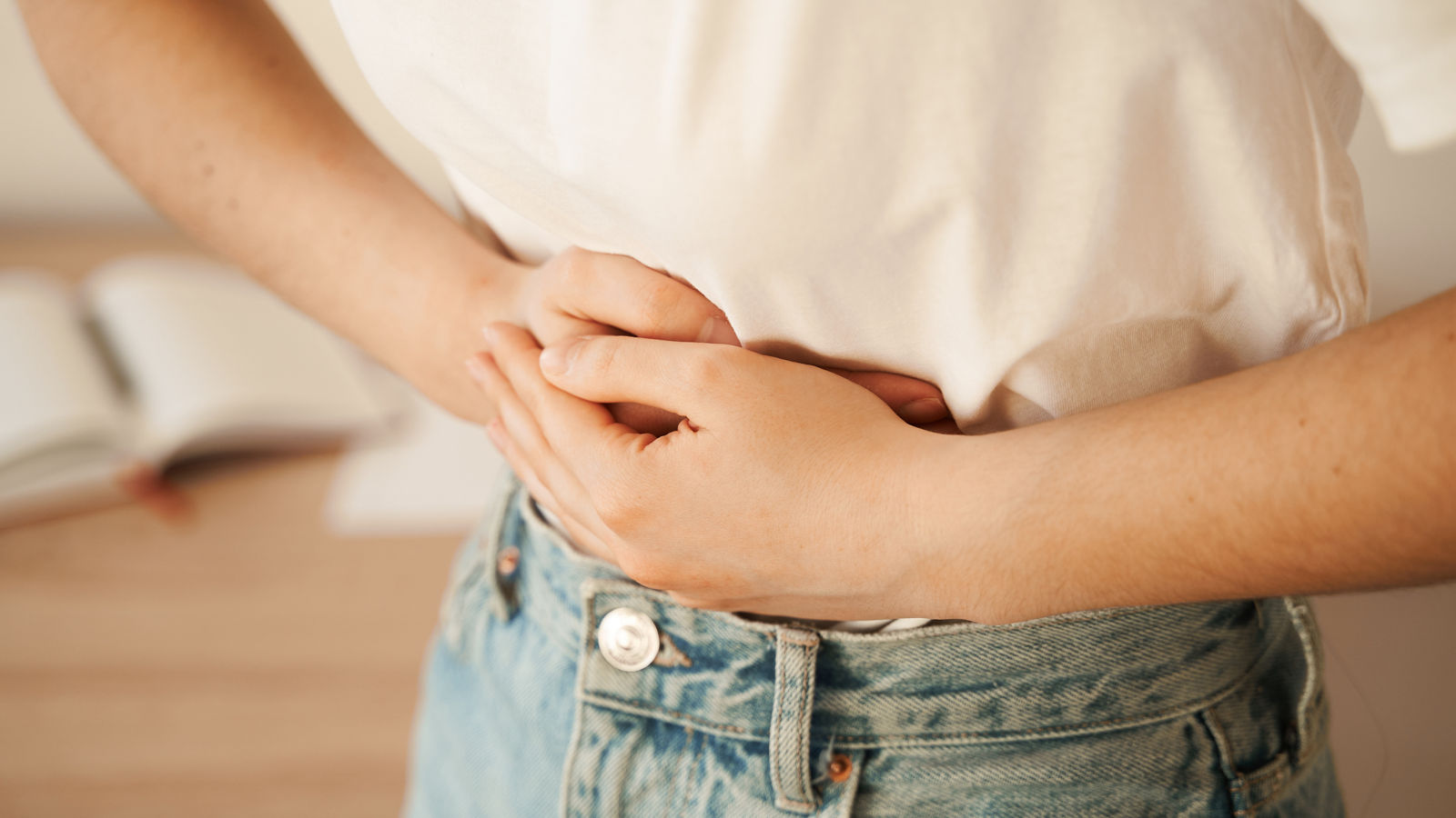 Stomach pain. Gastritis is an inflammation, irritation, or erosion of lining of stomach. Sick girl hold abdomen because it hurts.