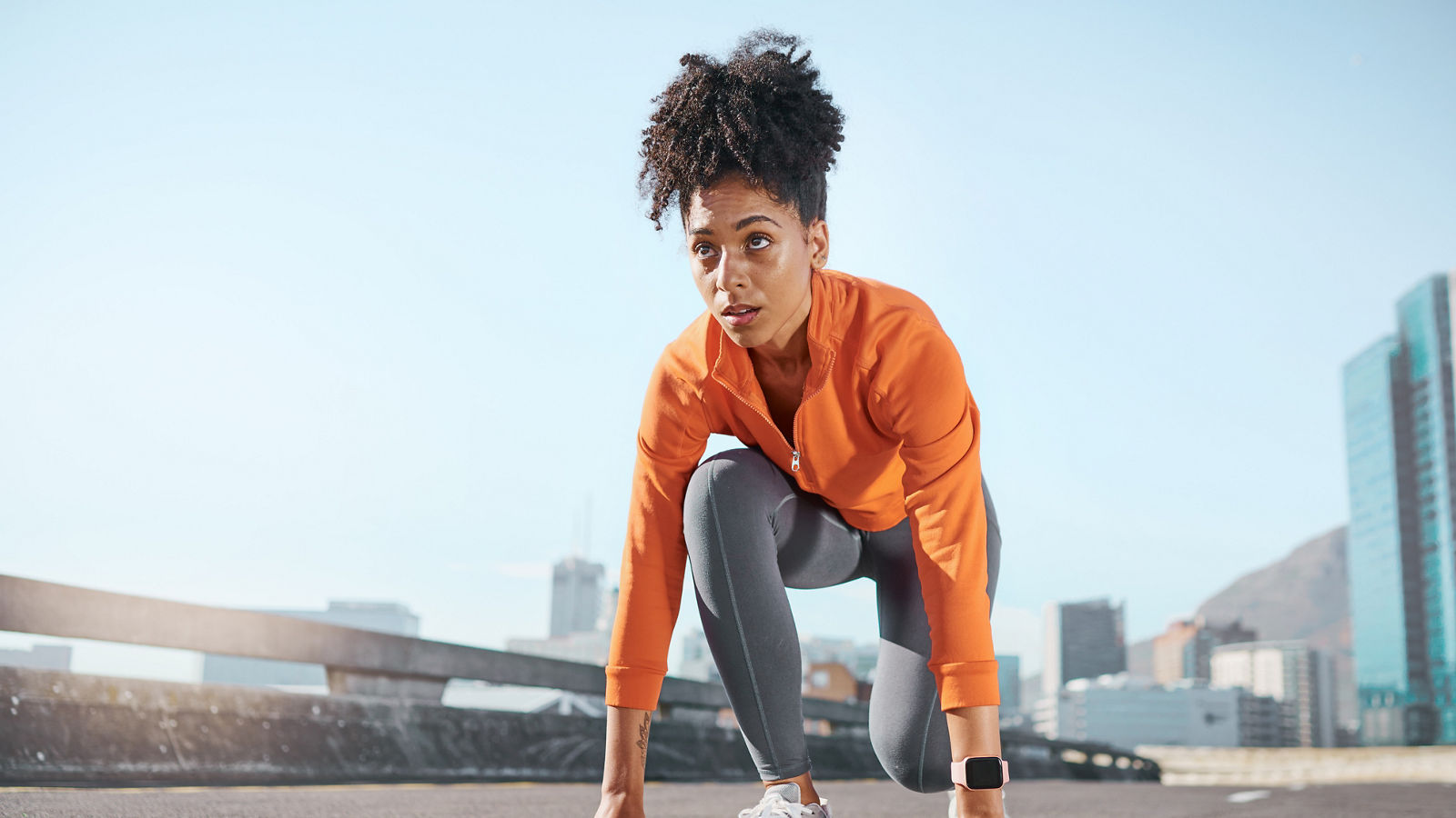 Runner, black woman and street for race, start or sprint in exercise, workout and training in city. Woman, focus and running for fitness, sport and health on road, metro or urban town in sunshine