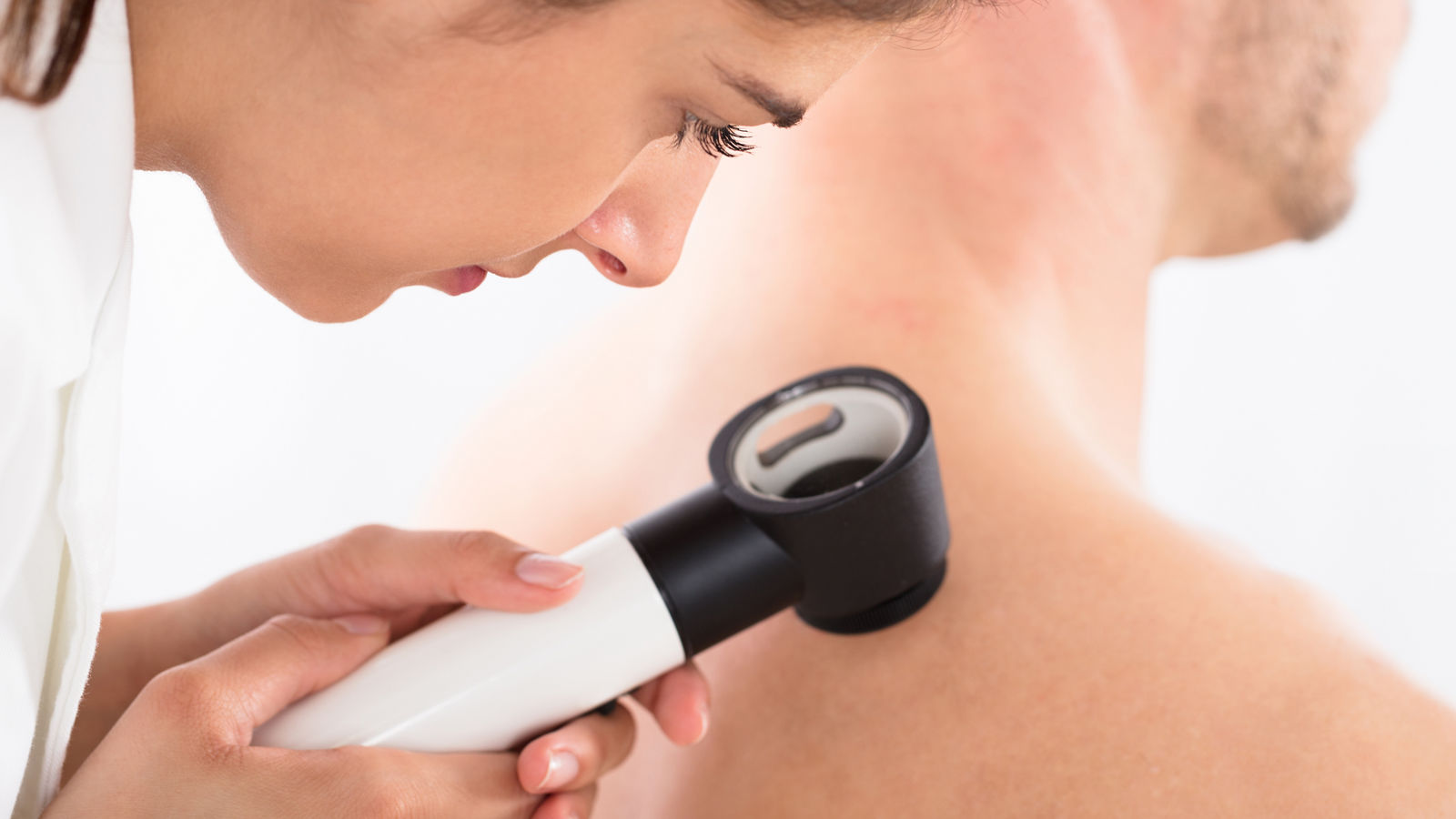 Doctor Using Dermatoscope For Skin Examination