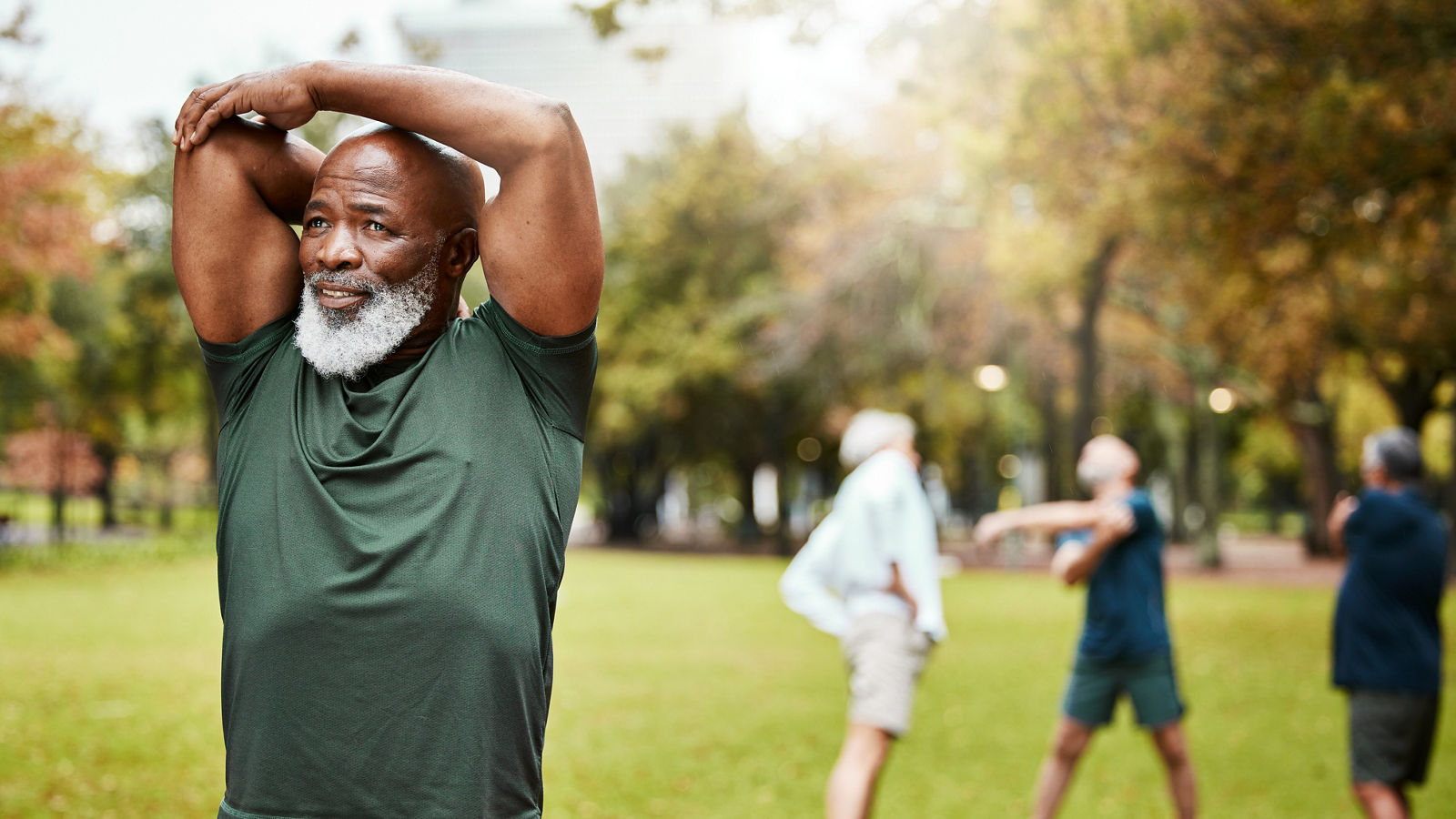 Black man, exercise and senior stretching in park, fitness and workout, energy and healthy lifestyle outdoors. African old man training with motivation in nature for strong body, wellness and sports