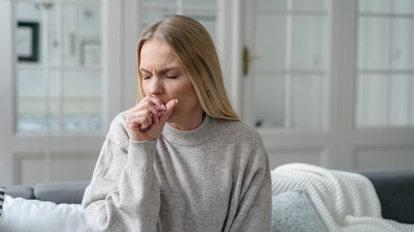 sick female coughing and has viral infection