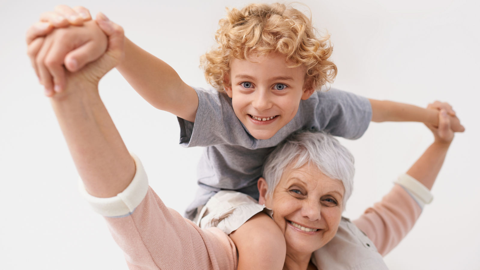 Portrait, piggyback or grandma with a happy child or smile hugging with love in family home. Elderly grandmother, boy or fun old woman relaxing, bonding or playing together in retirement on holiday