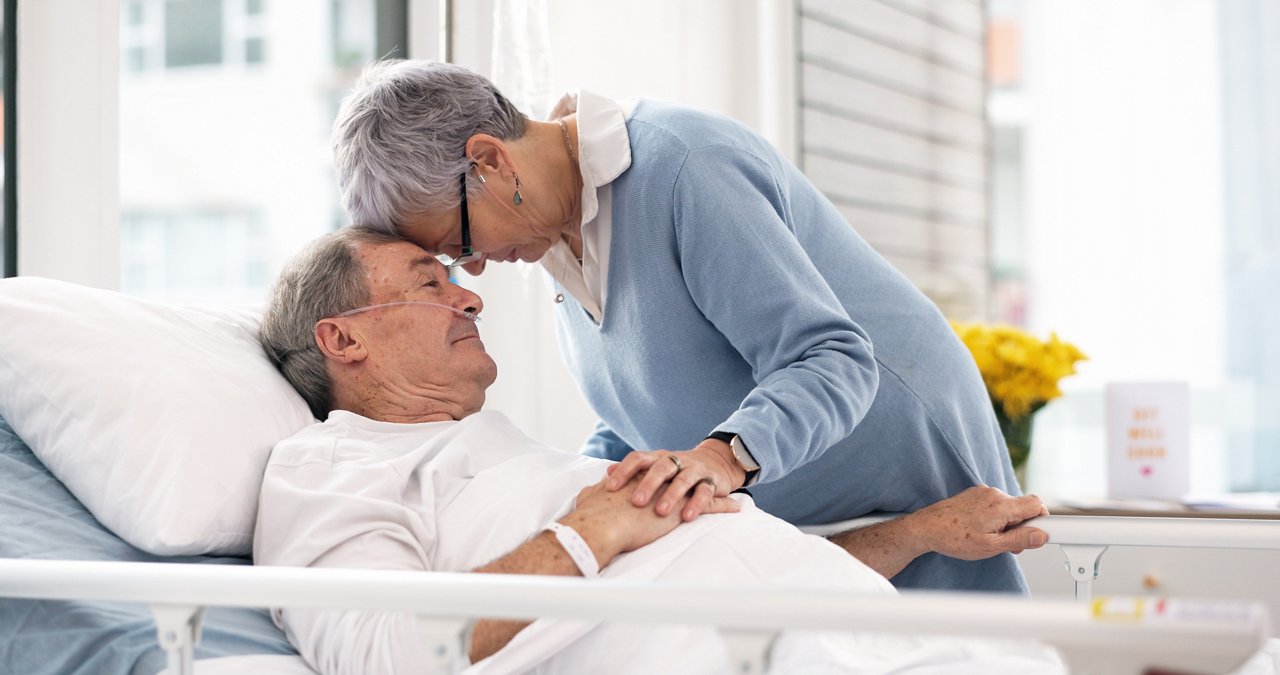 Hospital, love or elderly couple, sick patient and affection for empathy, marriage bond and support for senior person. Retirement healthcare, forehead and man with medical problem, cancer or disease.