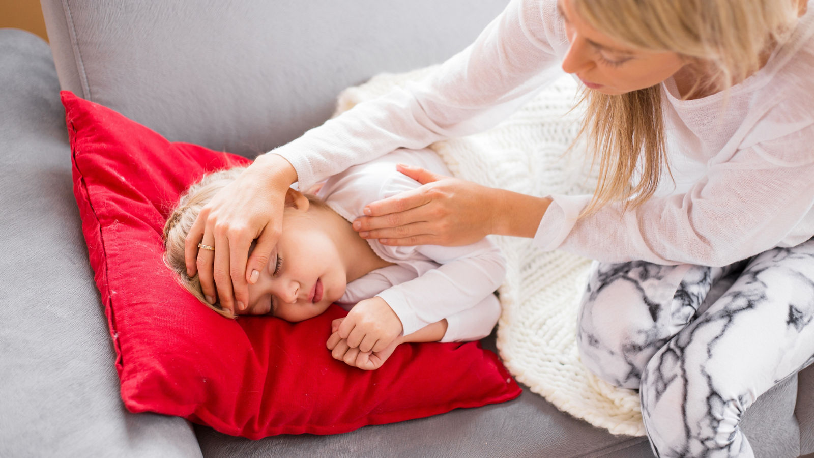 Mother looking after her sick child at home