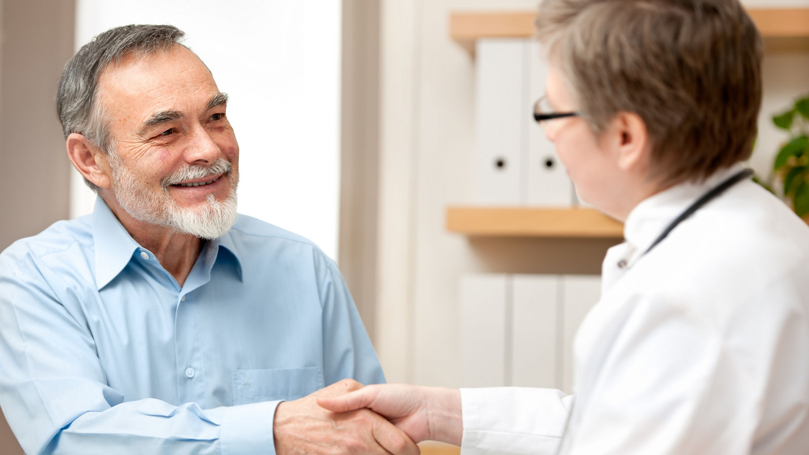 Doctor shaking hands to patient