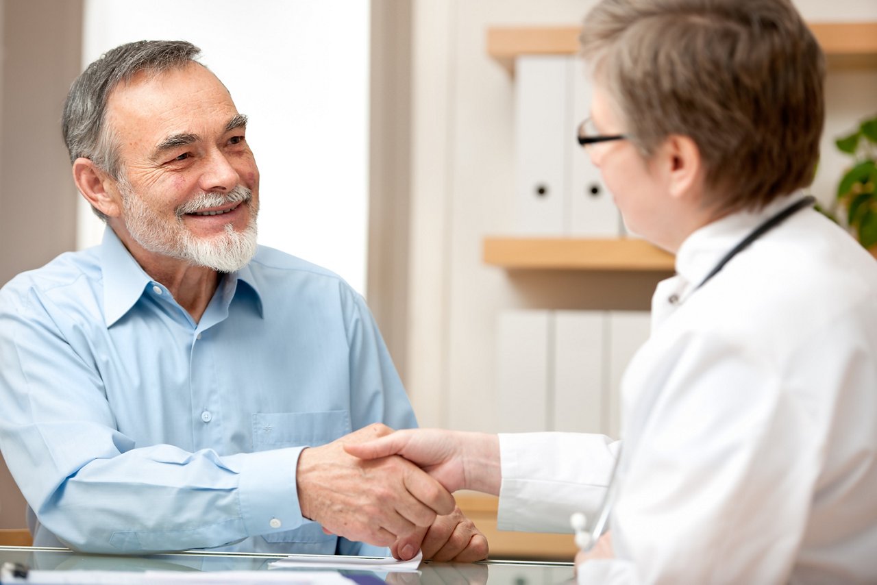 Doctor shaking hands to patient in the office