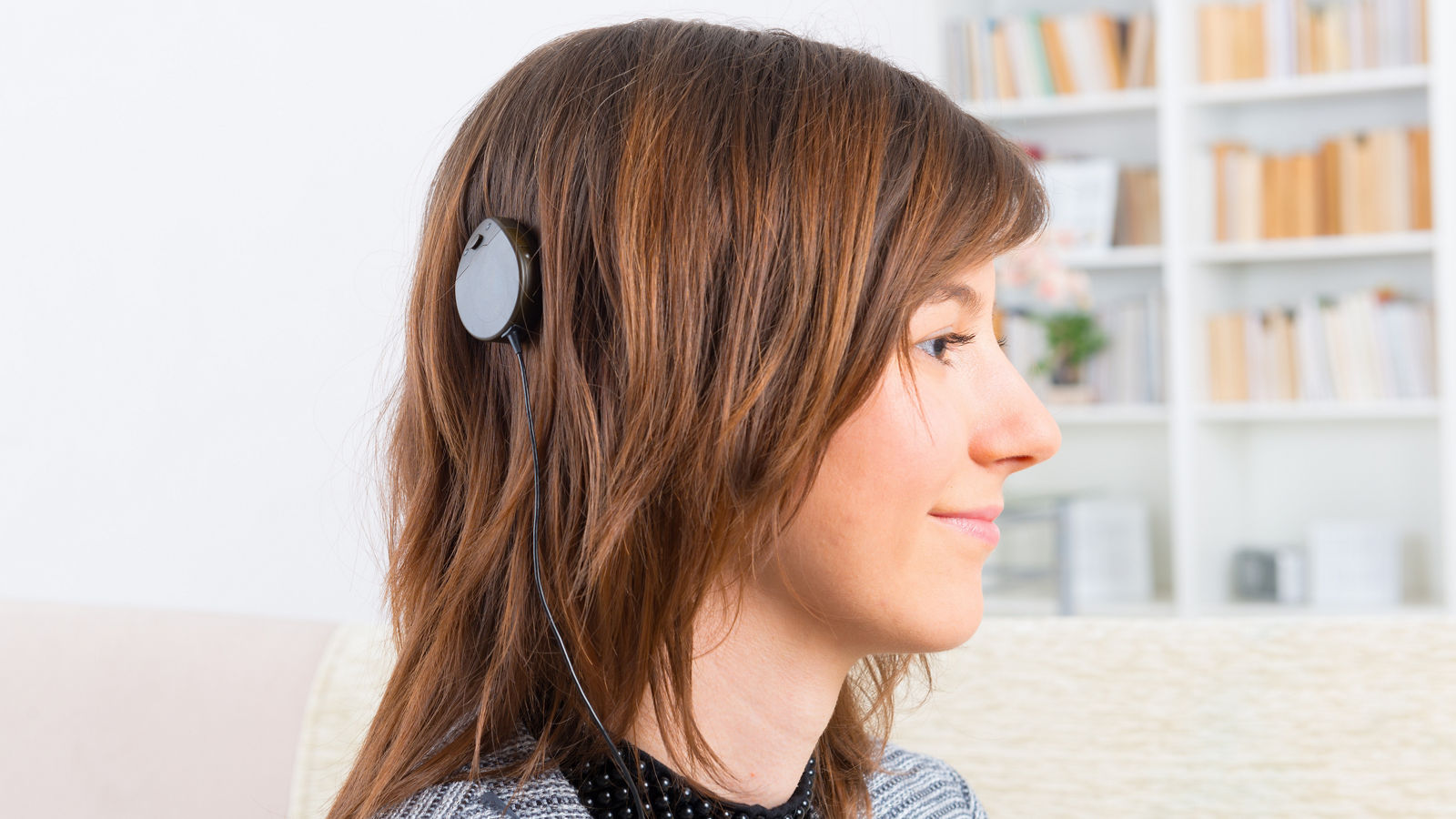 Woman showing cochlear implant