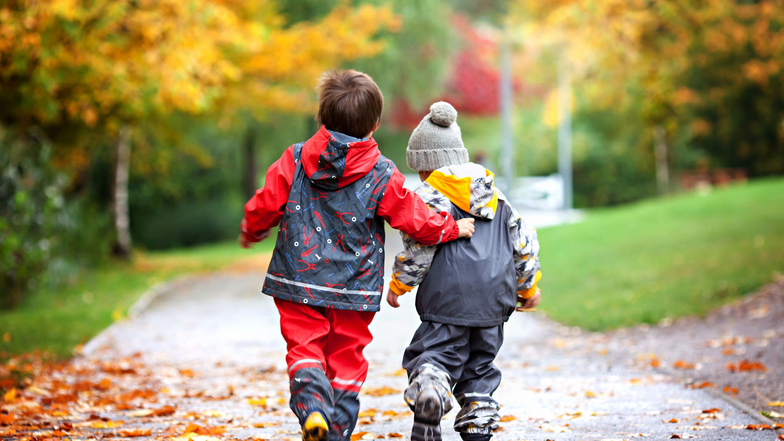 Two children, fighting over toy in the park on a rainy day