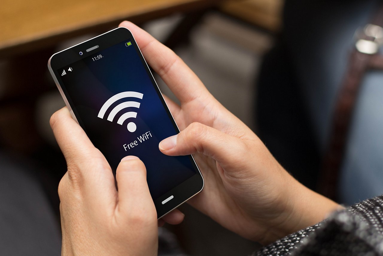 girl using a digital generated phone with free wifi on the screen. All screen graphics are made up.