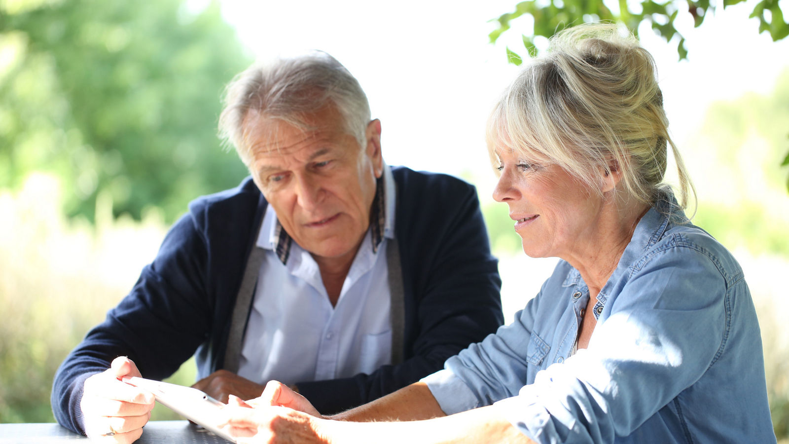 Senior couple using digital tablet
