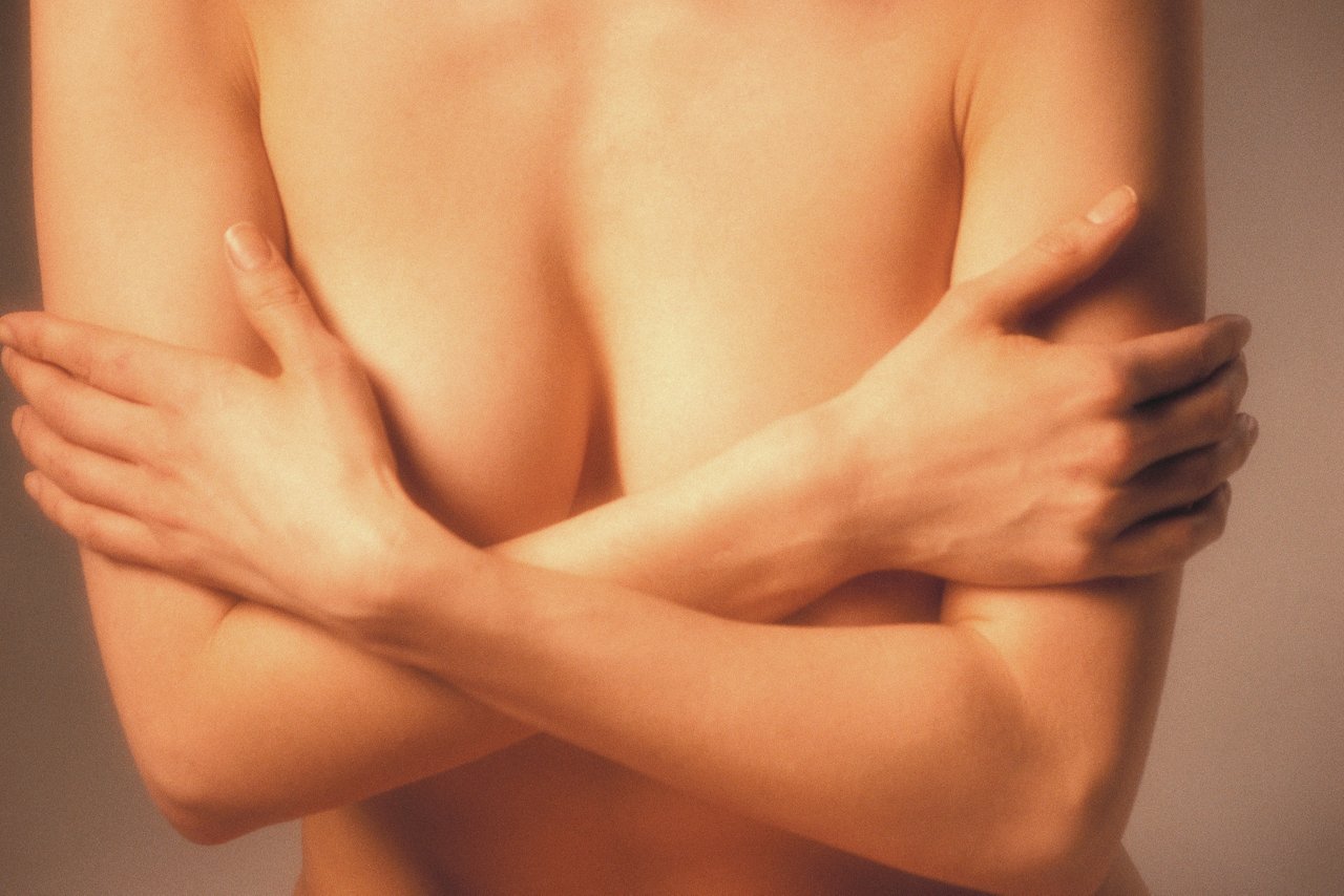 ca. 2000 --- Nude Woman Crossing Arms --- Image by © Royalty-Free/Corbis