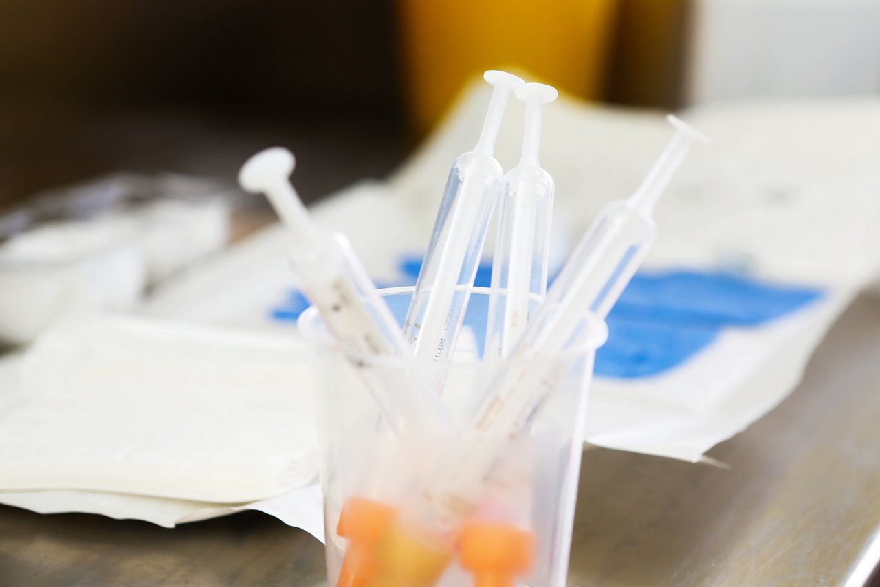 Becher mit Blutröhrchen auf dem Tisch