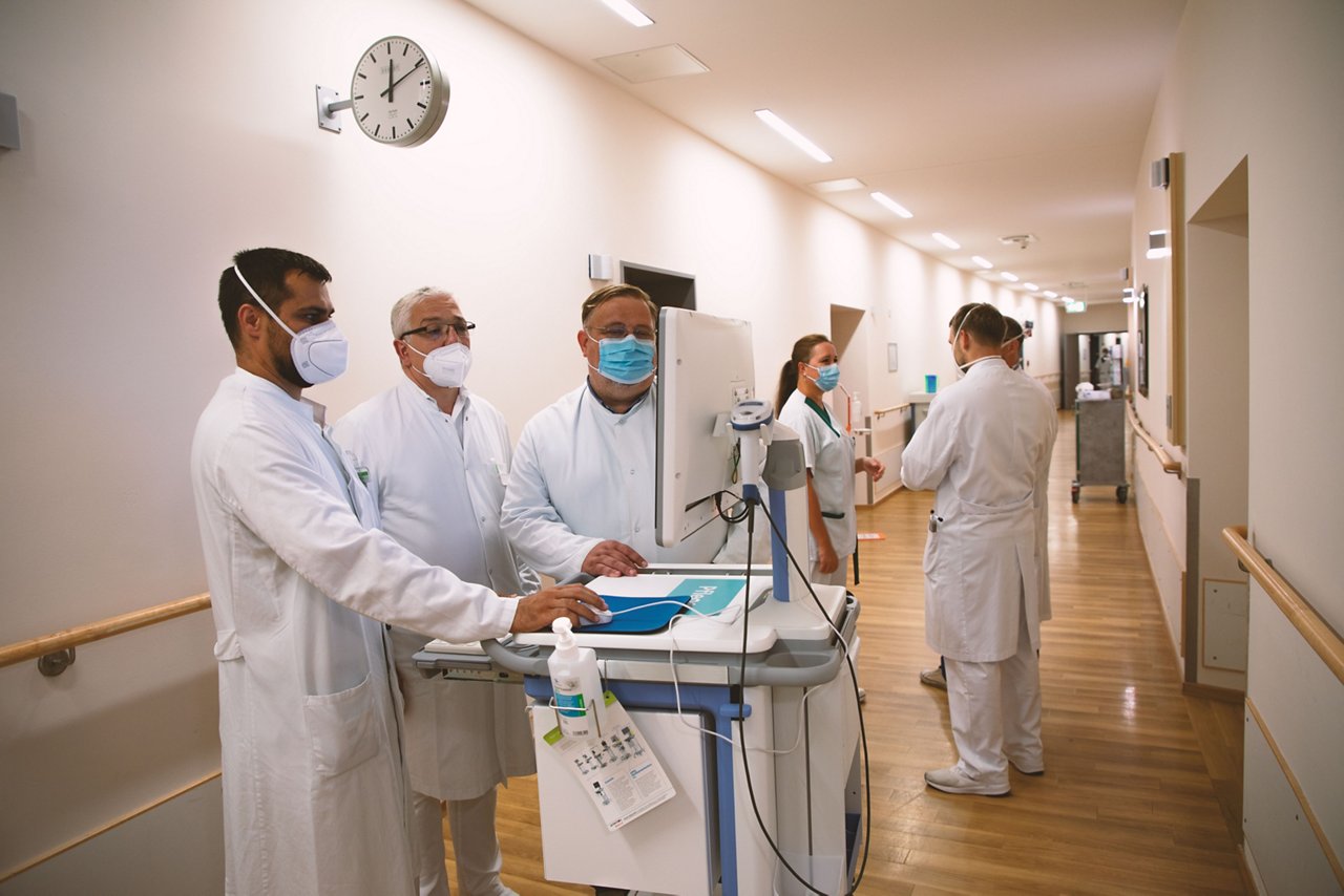 Ärzte besprechen einen Befund bei der Visite.