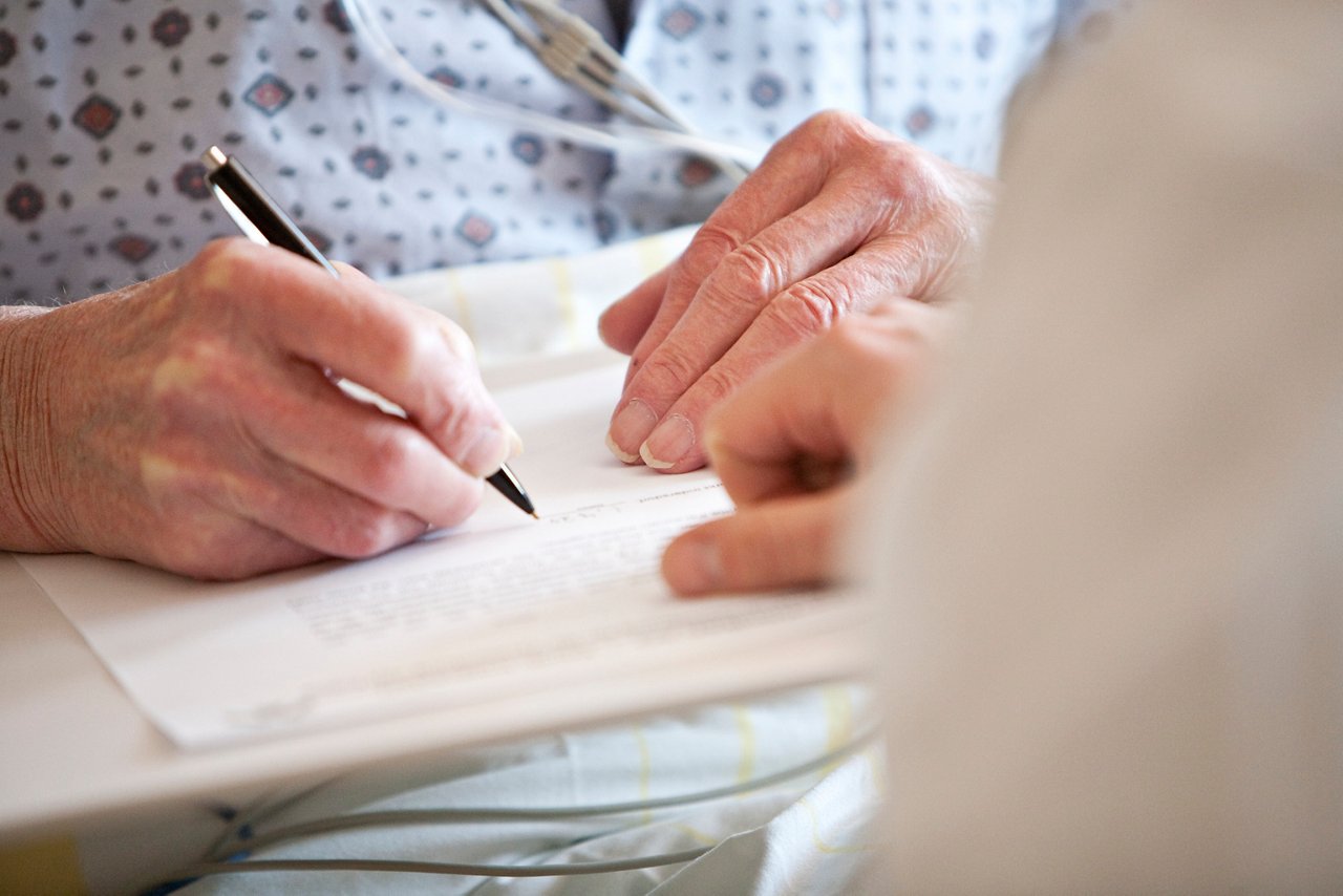 Patient unterschreibt Dokument