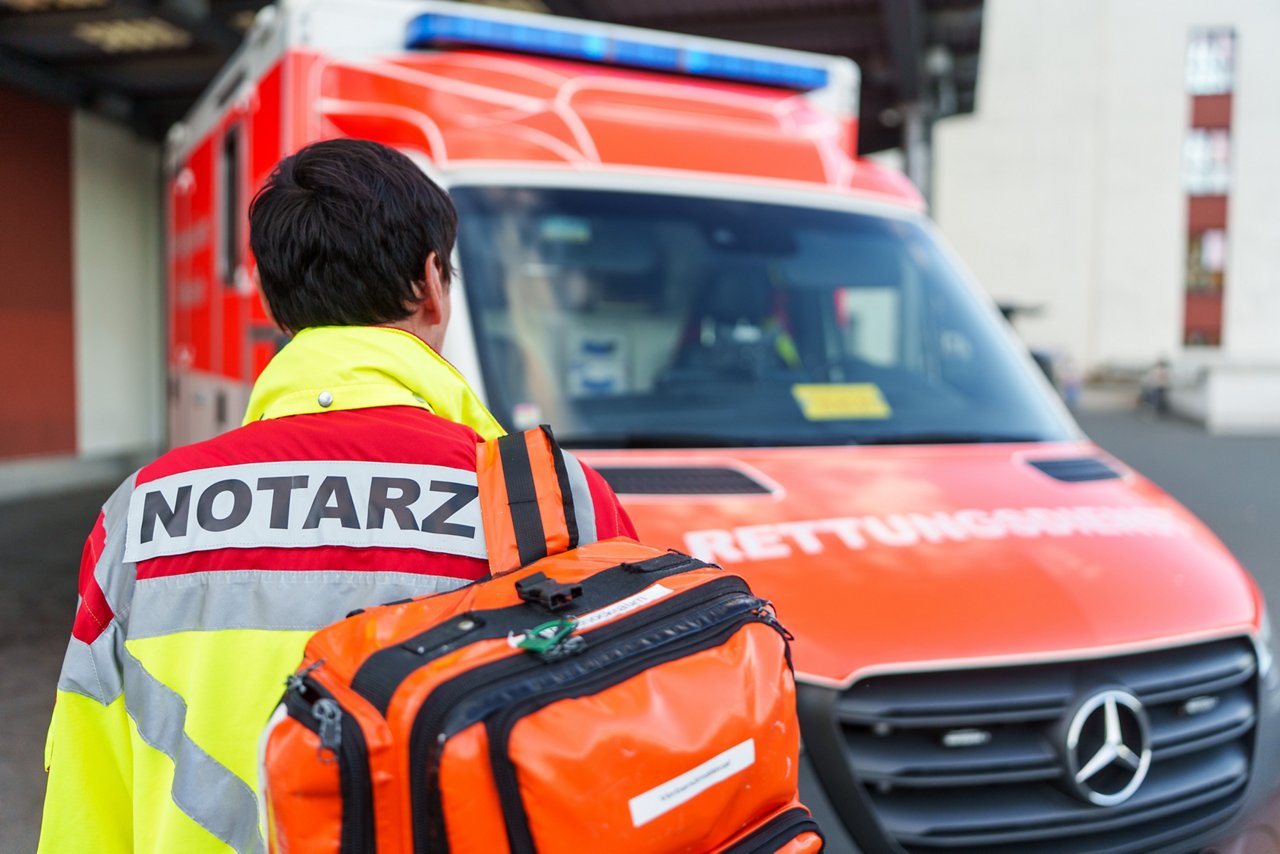 Notarzt ist auf dem Weg zum Rettungswagen mit seiner Ausrüstung