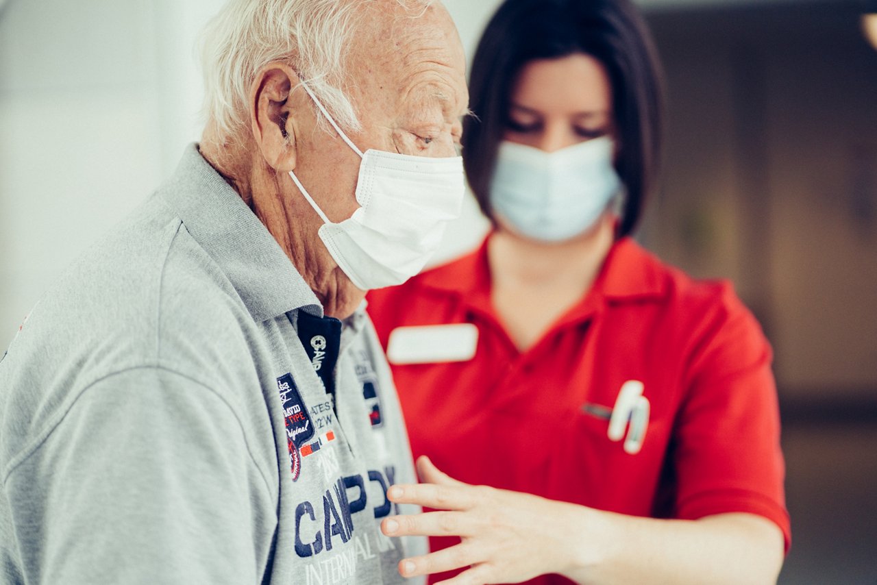 Physiotherapeutin prüft die Körperhaltung des Patienten