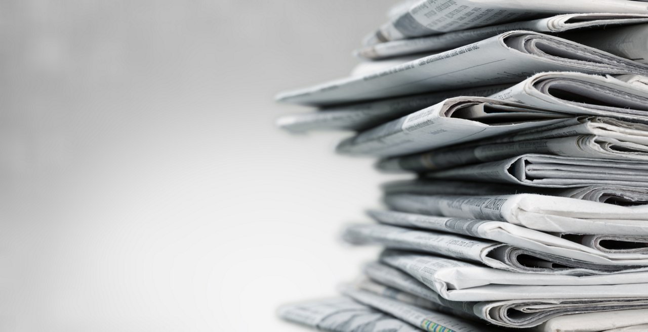 Pile of newspapers on white background