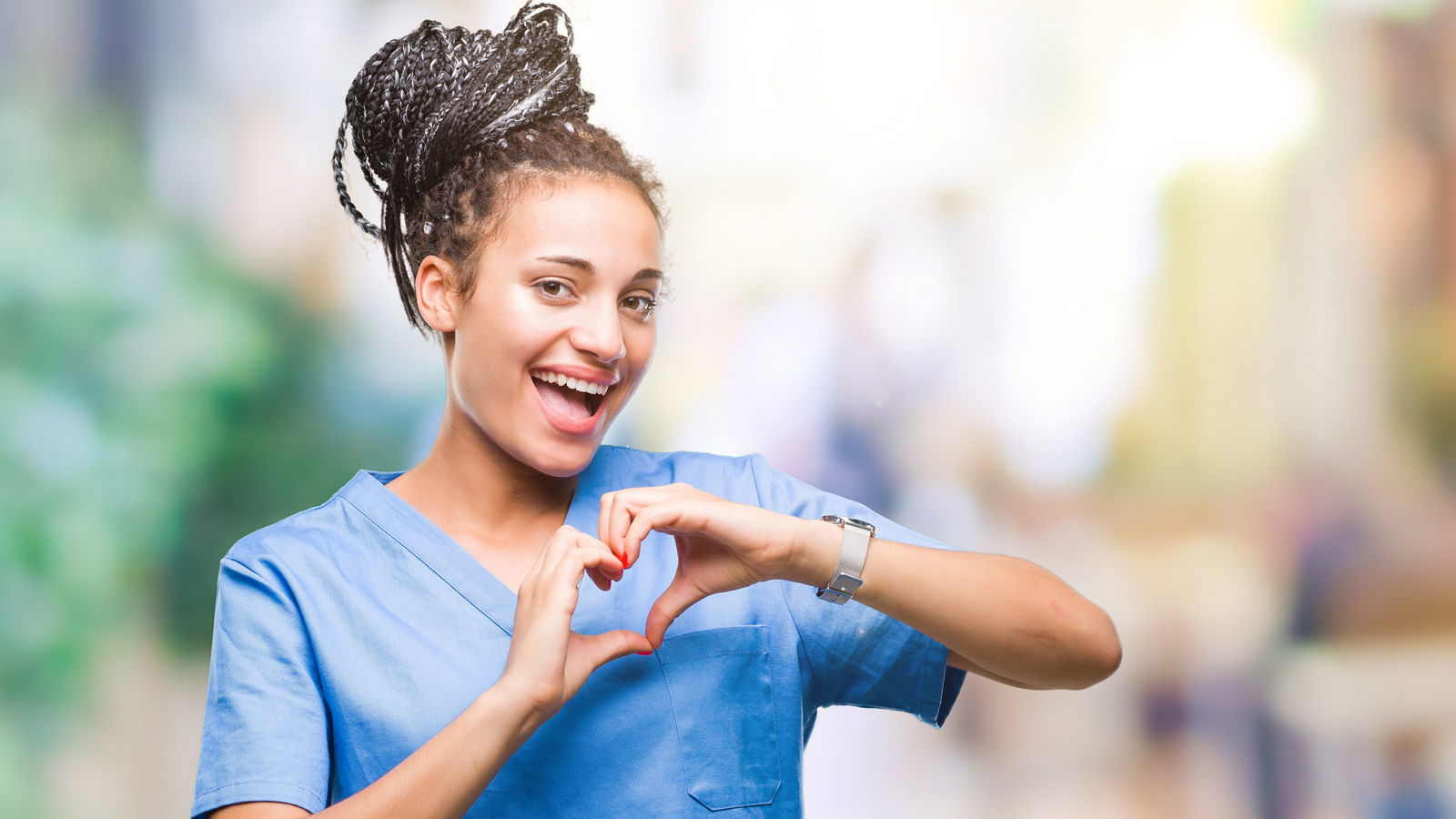 Young braided hair african american girl professional nurse over isolated background smiling in love showing heart symbol and shape with hands. Romantic concept.