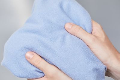 Mains touchant la texture d’un article en cachemire BOSS