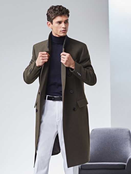 Dark green coat and navy pullover with white trousers by BOSS