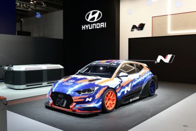 A front view of the Hyundai Veloster N ETCR, the first-ever electric race car by Hyundai Motorsport.