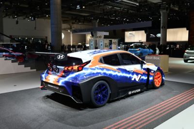 A side view of the Hyundai Veloster N ETCR, the first-ever electric race car by Hyundai Motorsport.