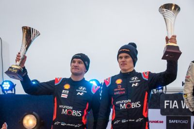 Hyundai Motorsport driver Ott Tänak and co-driver Martin Järveoja holding their trophies aloft