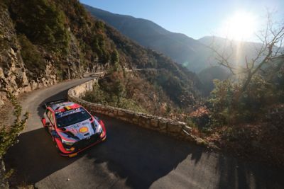 Rallye Monte Carlo and the Hyundai i20 Coupe WRC on a curvy road.