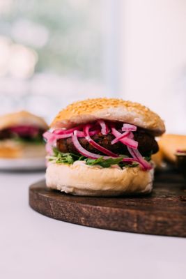 A veggie burger with red onions by Ella Mills Plant-based Challenge