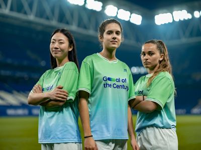 Three female footballers on the pitch wearing Hyundai Goal of the Century jerseys.
