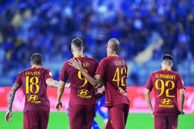 Photo of a group of Roma players celebrating, with the Hyundai logo visible on their shirts.