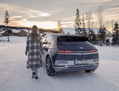 The Hyundai IONIQ 5 driving through snow and cold weather.