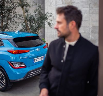 The Hyundai IONIQ 5 electric vehicle getting plugged in by its driver.